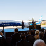 The image shows a large Boeing 787 Dreamliner aircraft on display.