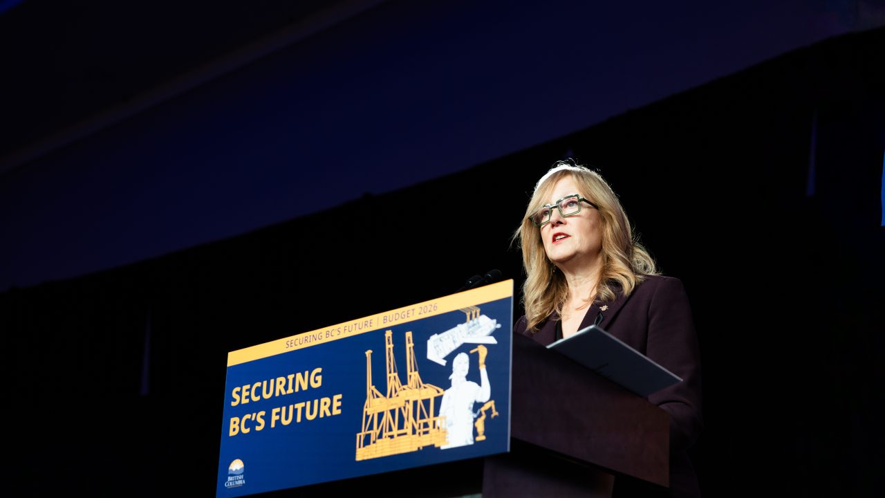 B.C. Finance Minister presents the 2026 provincial budget in Victoria at a podium displaying the slogan “Securing BC’s Future | Budget 2026.”