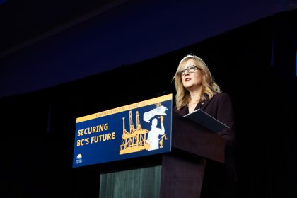 B.C. Finance Minister presents the 2026 provincial budget in Victoria at a podium displaying the slogan “Securing BC’s Future | Budget 2026.”