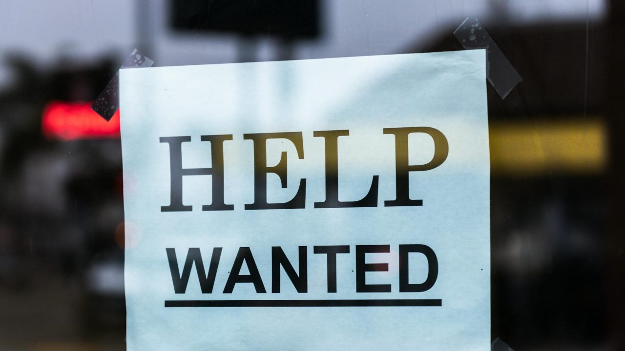 help wanted sign on glass