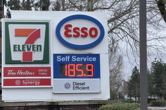 Esso gas station sign showing gasoline price at 185.9 cents per litre at a 7-Eleven location in Langley, British Columbia.